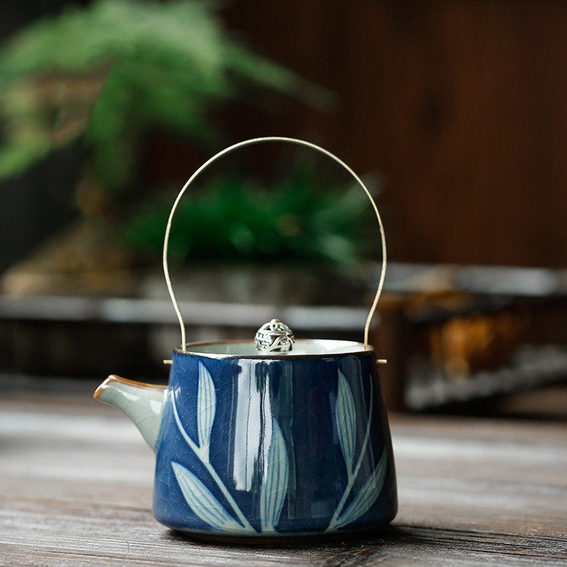 Hand-painted ceramic teapot with blue glaze finish